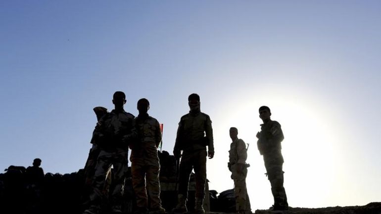 Kurdish Peshmerga fighters stand guard on Sept. 27, 2014, during...