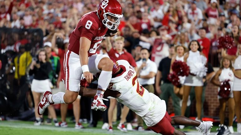 Oklahoma quarterback Dillon Gabriel (8) leaps past Iowa State defensive...