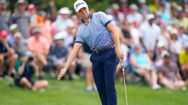 Justin Thomas reacts after missing a putt on the seventh...