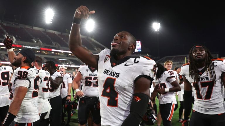 Oregon State quarterback Gevani McCoy reacts after winning against San...