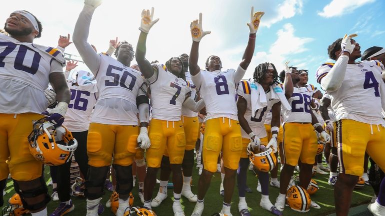 LSU celebrates a come from behind win after an NCAA...