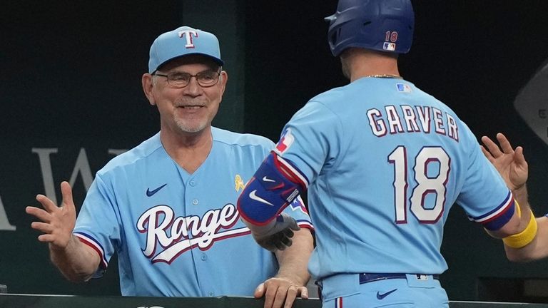 Texas Rangers manager Bruce Bochy, left, congratulates Mitch Garver after...