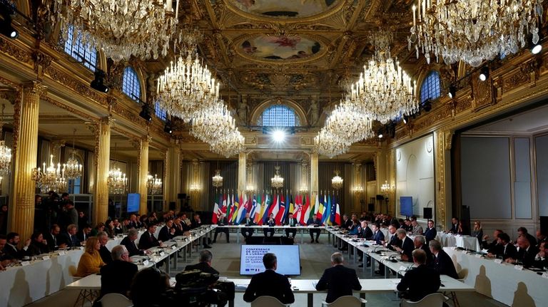 French President Emmanuel Macron, center right, delivers a speech at...