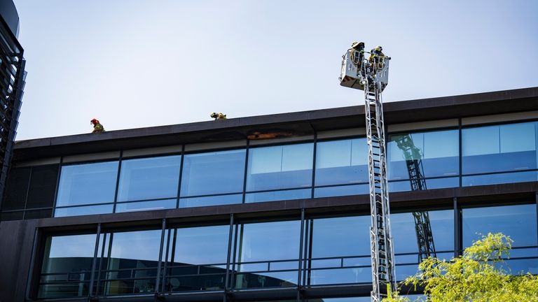 Firefighters work to extinguish a fire at the building housing...