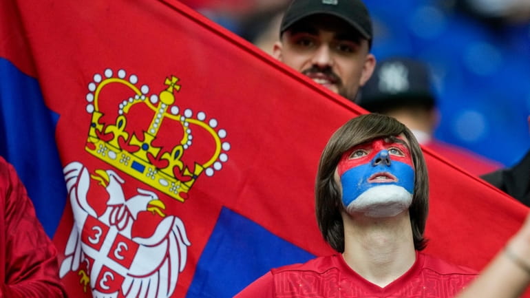 Serbia's fans chant ahead of a Group C match between...
