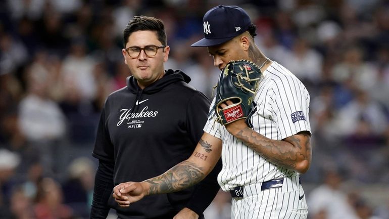 Luis Gil of theYankees leaves a game in the fourth inning...