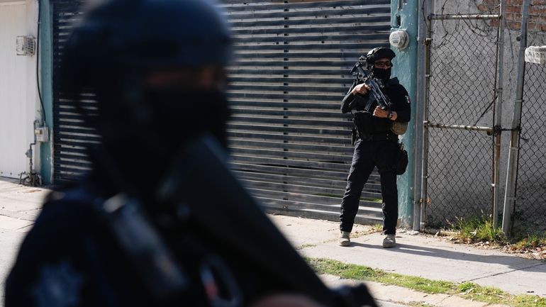 Municipal police officers patrol a neighborhood in Celaya, Guanajuato state,...