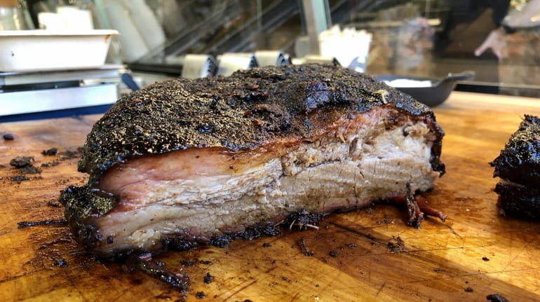 Brisket at Mighty Quinn's in Garden City is smoked, Texas...