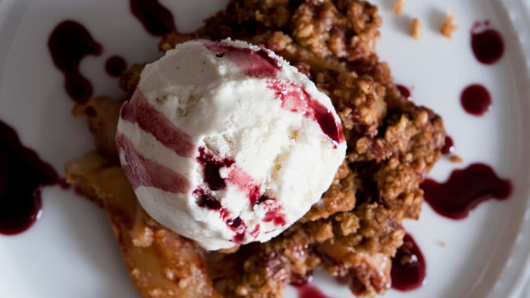 Cranberry pear crisp is served with ice cream and port...