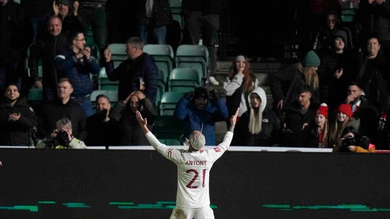 Manchester United's Antony celebrates after scoring his side's third goal...