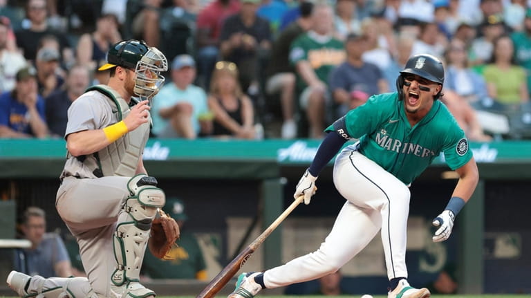 Seattle Mariners' Josh Rojas reacts after fouling a ball off,...
