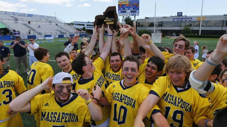 The Massapequa Chiefs celebrate after defeating the Fayetteville-Manlius Hornets to...