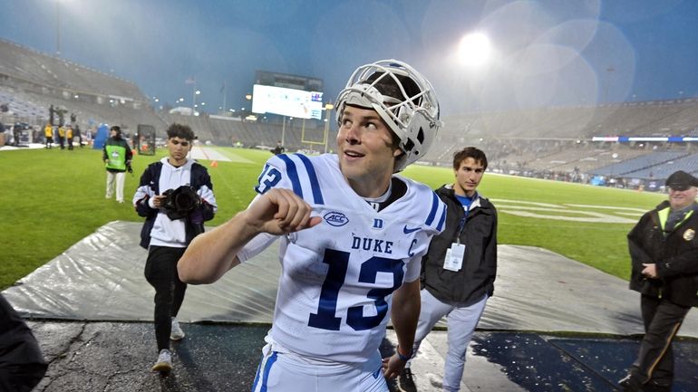 Duke quarterback Riley Leonard (13) reacts to fans after their...