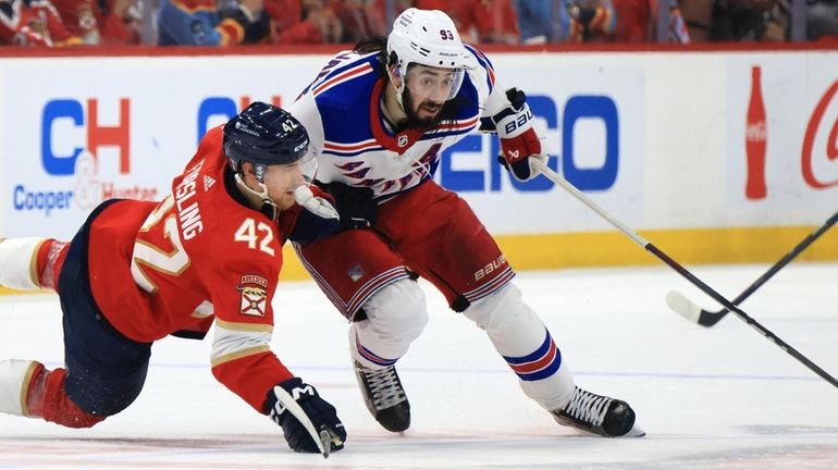 Mika Zibanejad of the New York Rangers and Gustav Forsling...