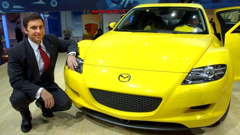 Mazda Motor Corp. president Mark Fields with the Mazda RX-8,...