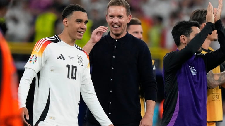 Germany's head coach Julian Nagelsmann, center, and Jamal Musiala celebrate...