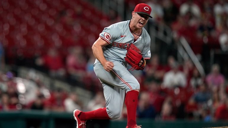 Cincinnati Reds relief pitcher Emilio Pagan celebrates after striking out...