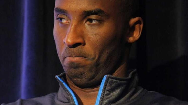 Los Angeles Laker's Kobe Bryant listens during a news conference...