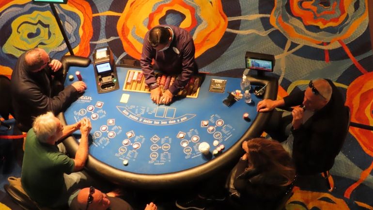 Gamblers play cards at the Ocean Casino Resort in Atlantic...