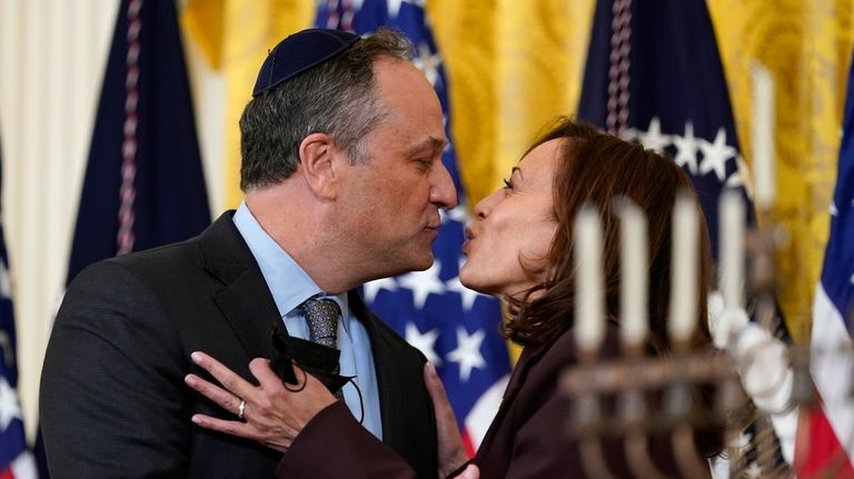 Vice President Kamala Harris and second gentleman Doug Emhoff kiss...