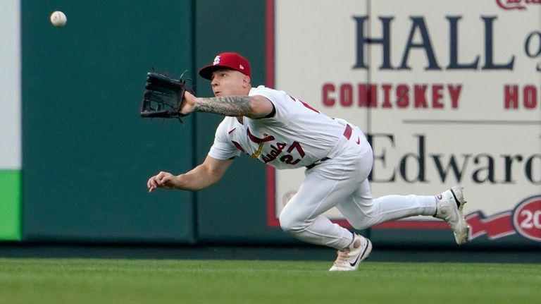 St. Louis Cardinals center fielder Tyler O'Neill dives to catch...