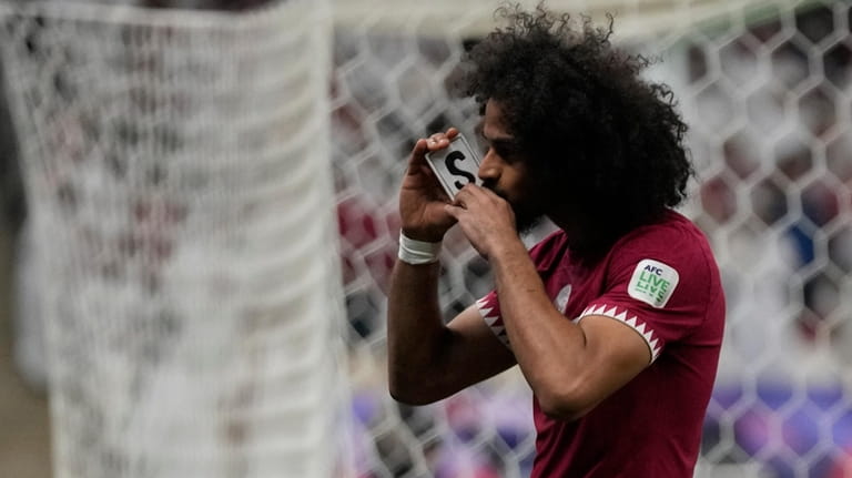 Qatar's Akram Afif celebrates after scoring his side's opening goal...