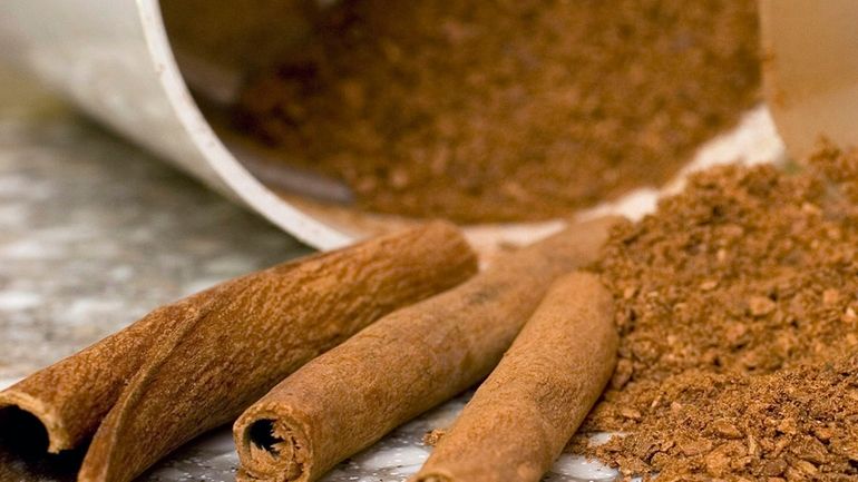 Stick and ground cinnamon is displayed for a photograph in...