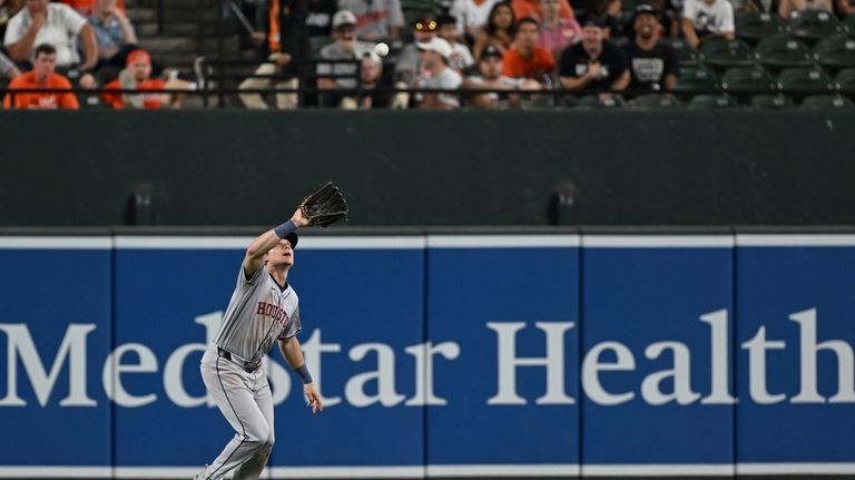 Houston Astros center fielder Jake Meyers catches a fly ball...