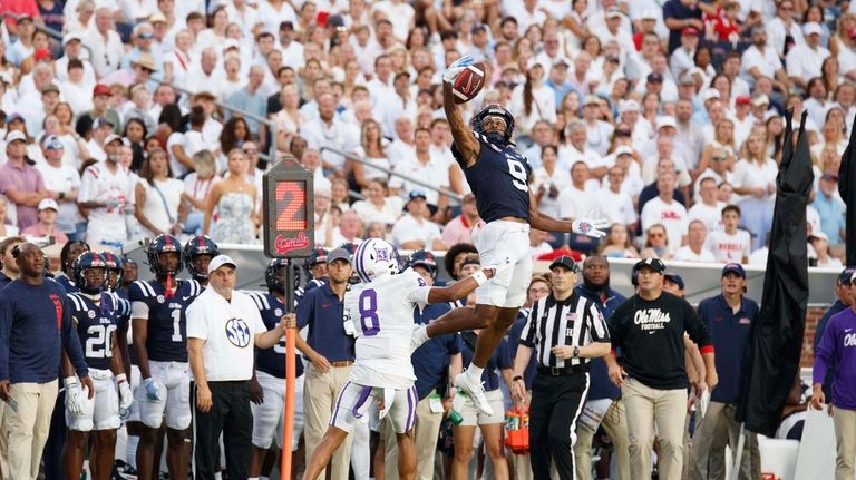 Mississippi wide receiver Tre Harris (9) attempts to catch a...