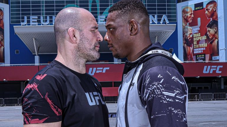 Glover Teixeira, left, and Jamahal Hill face off for the...