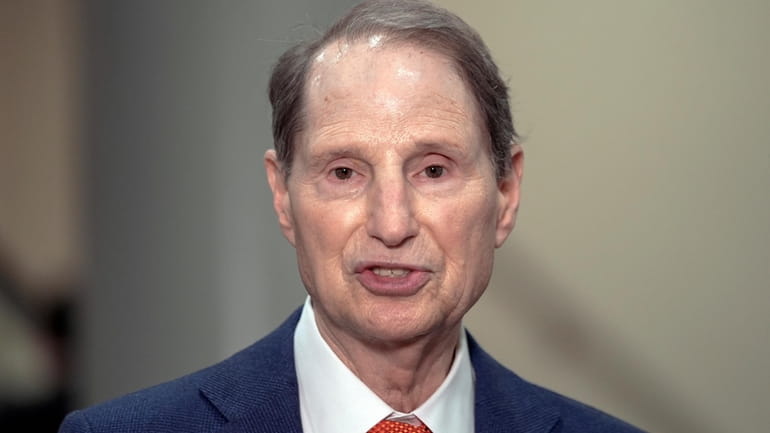 Sen. Ron Wyden, D-Ore., speaks with reporters on Capitol Hill...