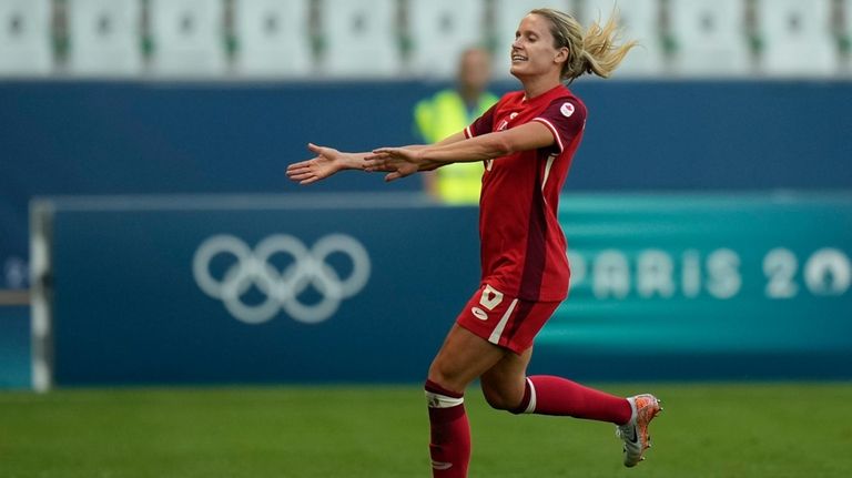 Canada's Cloe Lacasse celebrates scoring her side's first goal during...