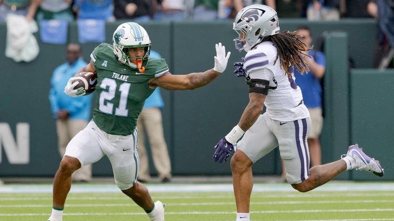 Tulane running back Makhi Hughes (21) runs against Kansas State...