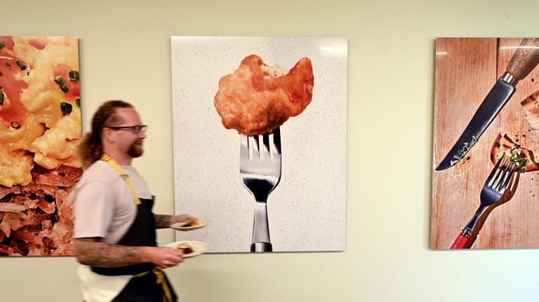 Chef Zach Tyndall carries plates of cultivated chicken at GOOD...