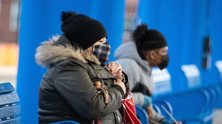 People wait at the Rosa Parks Hempstead Transit Center on...