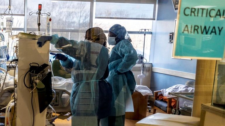 A team of doctors and nurses checking on a patient...