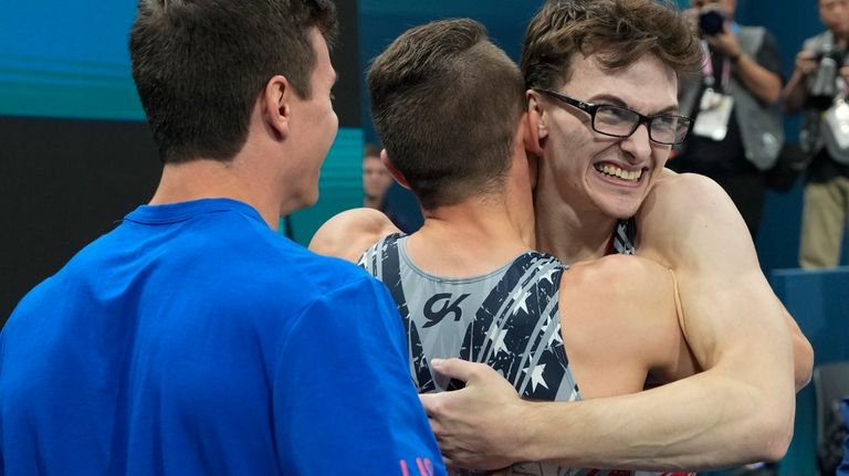 Stephen Nedoroscik, of United States, gets a hug from Paul...