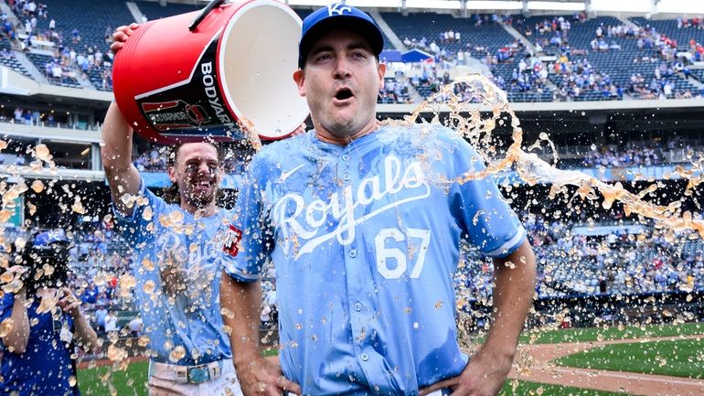 Kansas City Royals starting pitcher Seth Lugo (67) is doused...