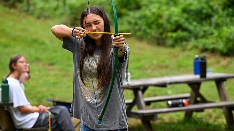 Leah Clutter, 16, of Long Beach, practices her archery aim...