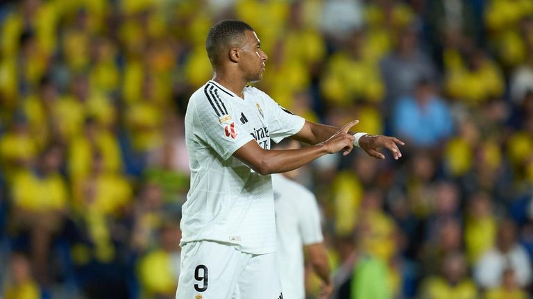 Real Madrid's Kylian Mbappe protests to referee Mateo Busquets Ferrer...