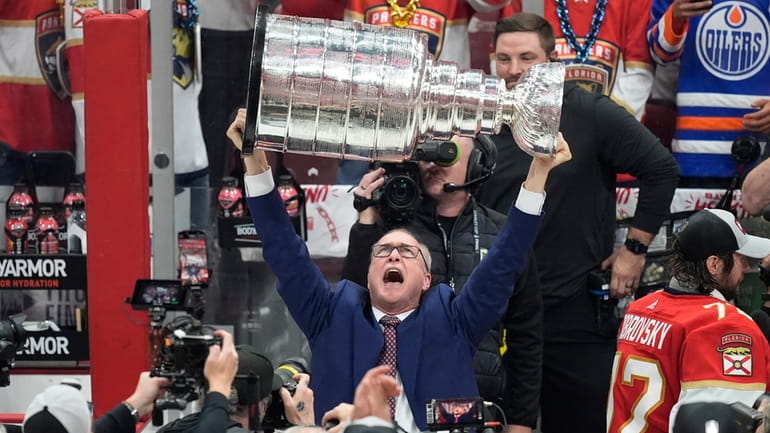 Florida Panthers head coach Paul Maurice lifts the Stanley Cup...