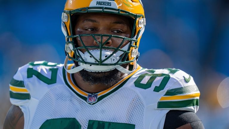 Green Bay Packers defensive tackle Kenny Clark (97) warms up...