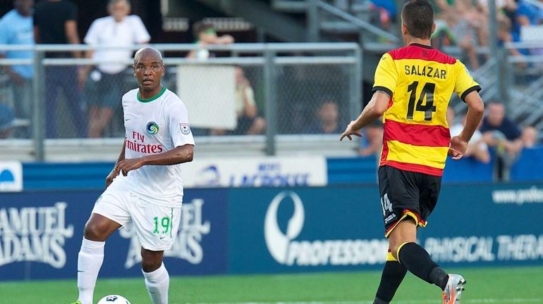 Cosmos midfielder Marcos Senna looks for an open lane to...