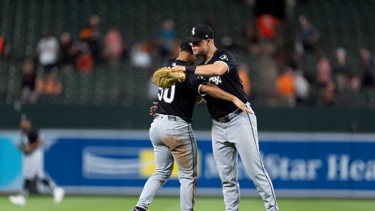 Chicago White Sox third baseman Lenyn Sosa, left, and relief...