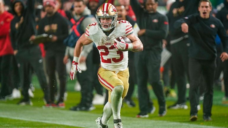 San Francisco 49ers running back Christian McCaffrey runs with the...