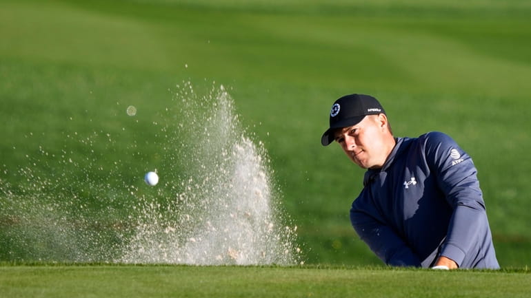 Jordan Spieth blasts from the sand trap along the 11th...