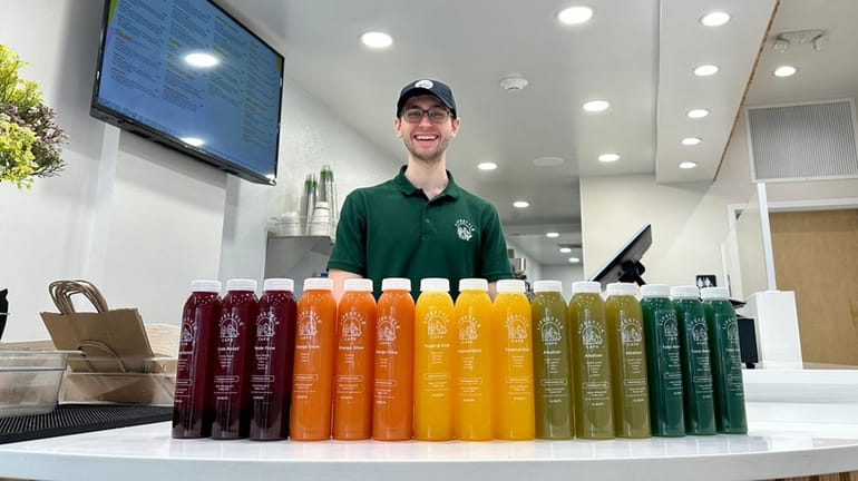 Owner Tom Ligouri serves fresh-pressed juices at Lifestyle Cafe in Port...