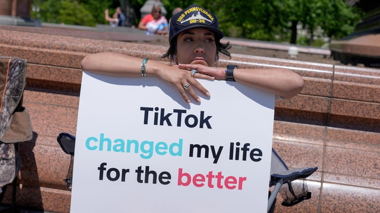 A TikTok content creator, sits outside the U.S. Capitol, Tuesday,...