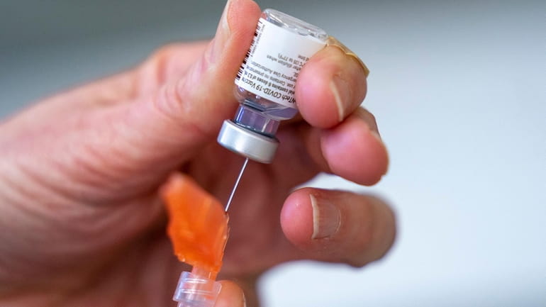 A syringe is loaded with the Pfizer-BioNTech COVID-19 vaccine.