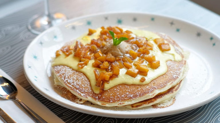 Pineapple upside down pancakes are topped with house-made vanilla rum...